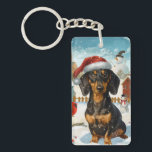 Porte-clés Dachshund Winter Wonderland Christmas Joy<br><div class="desc">Ce design festif reflète l'esprit joyeux de la période des fêtes, avec un adorable petit portant un chapeau de Père Noël. Le chien est niché dans un pays des merveilles hivernales, avec un bonhomme de neige, un sapin de Noël décoré et des cadeaux joliment emballés. Les flocons de neige tombent...</div>