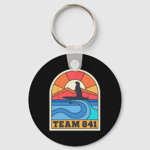 Porte-clés Équipe 841 Loutre surfant sur la plage californien