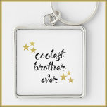 Porte-clés Frère noir et or le plus froid jamais<br><div class="desc">COOLEST BROTHER JAMAIS dans la police de script - décoré avec des étoiles.</div>