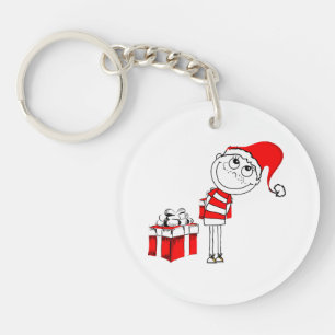 Porte-clés Garçon au chapeau de Père Noël cachant un cadeau d