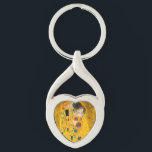 Porte-clés Gustav Klimt Le Baiser<br><div class="desc">Porte - clé avec la peinture à l’huile de Gustav Klimt avec la feuille d’or The Kiss (1908). Un homme et une femme, aux couleurs dorées brillantes, embrassent et embrassent avec amour dans un champ de fleurs. Un grand cadeau pour les amateurs d'art Art Nouveau et autrichien.</div>