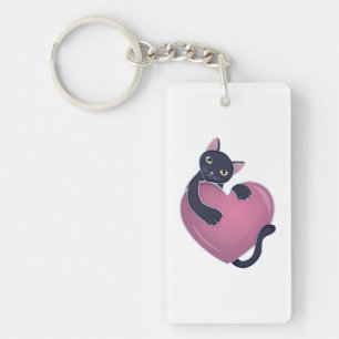 Porte-clés Joli chat noir s'accrochant à un gros cœur