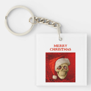 Porte-clés Joyeux Noël. Crâne portant un chapeau de Père Noël