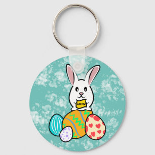 Porte-clés Lapin de Pâques tenant une bannière sur les oeufs