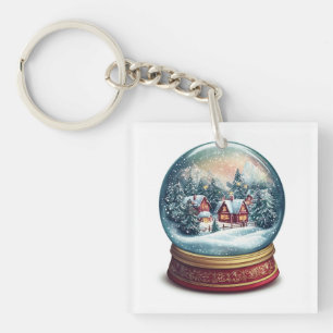 Porte-clés Le globe de neige de Noël avec un design de villag
