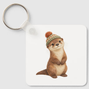 Porte-clés Loutre en bas âge portant un chapeau tricoté