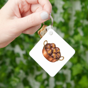Porte-clés Marrons rôtis dans une poêle en cuivre