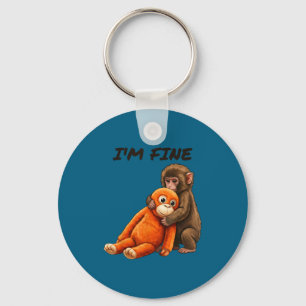 Porte-clés Mème de singe triste frappé avec un jouet orange j