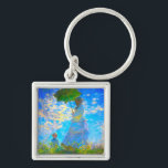 Porte-clés Monet Woman avec un parasol<br><div class="desc">Un porte - clé de portrait familial,  avec Camille,  épouse de Claude Monet,  tenant un parasol,  et son fils Jean,  se promène dans un champ vert vif soufflé par le vent pendant une journée d’été. Un grand cadeau Monet pour les amateurs d'impressionnisme et d'art français.</div>