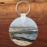 Porte-clés Morro Bay California Coastal Photography<br><div class="desc">A foggy overcast day in Morro Bay California with the ocean waves hitting the rocks on the shore in this beach photograph souvenir. This seaside travel photo keepsake keychain features black cursive script above the beach rocks and grey sky.</div>