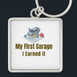 Porte-clés My First Garage Keychain – I Earned It – Proud Fir<br><div class="desc">Celebrate the pride of owning your very first garage or workshop! This keychain features the bold phrase "My First Garage – I Earned It", perfect for anyone who worked hard to achieve this milestone. Whether it’s a personal garage, auto repair shop, or mechanical workshop, this keychain is a fun and...</div>