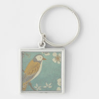 Oiseau jaune, gris et beige perché sur une branche