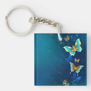 Porte-clés Papillons dorés sur fond bleu