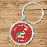 Porte-clés Penguin de Noël Obtenir un Porte - clé de boule de<br><div class="desc">Un petit dessin de pingouin portant un chapeau santa et une écharpe verte se pliant pour obtenir une boule de neige en évitant une autre. Couleur arrière - plan personnalisée. Texte personnalisé.</div>