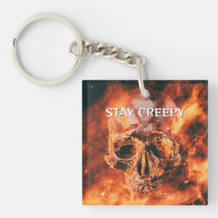 Porte-clés Reste Déplaisant. Crâne flamboyant dans l'espace