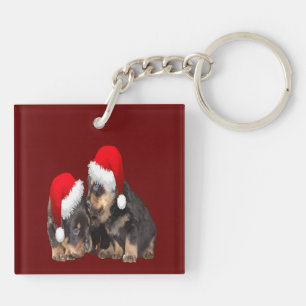Porte-clés Rottweilers de Noël portant des chapeaux de fête