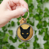 Porte-clés Silhouette de chat noir sur un cercle doré (Main)