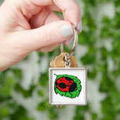 Porte-clés Smiling Ladybug sur une feuille verte (main)