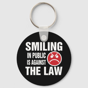Porte-clés Sourire en public est contre la loi