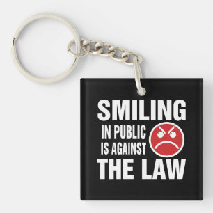 Porte-clés Sourire en public est contre la loi