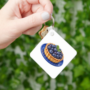 Porte-clés Tarte aux myrtilles sur une assiette bleue