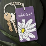 Porte-clés Texte personnalisé marguerite mauve et jaune<br><div class="desc">Un morceau d'art zen et fantaisiste,  hipster. Vous pouvez ajouter un nom,  un monogramme ou un autre texte personnalisé. Si vous avez besoin de déplacer l'art autour,  cliquez sur le bouton personnaliser pour apporter des modifications.</div>