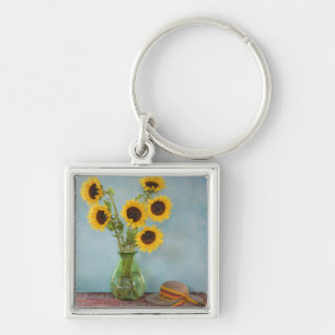 Porte-clés Tournesols dans un vase sur une table