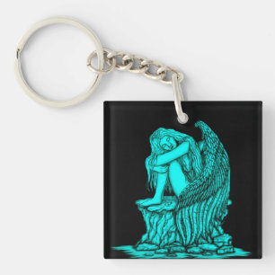 Porte-clés Un ange endormi sur la pierre