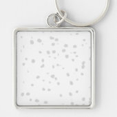 Porte-clés un arrière - plan blanc avec beaucoup de petits po (Devant)