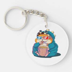Porte-clés Un drôle de hamster aux lunettes mange du pop-corn