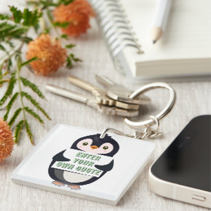 Porte-clés Un pingouin tenant un panneau avec un texte person
