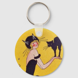Porte-clés Une fille en costume de chat avec son chat noir