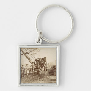 Porte-clés Une grue de vapeur en fonction pendant le bâtiment