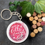 Porte-clés Vins un peu rire beaucoup<br><div class="desc">Porte - clé à bouton rond avec un texte amusant "Wine a Little Laugh A Lot" sur une tache de vin rouge. Les porte - clés font des cadeaux mémorables pour leur famille et leurs amis ou créent pour vous-même.</div>