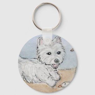 PORTE-CLÉS WESTIE JOUANT SUR LA PLAGE