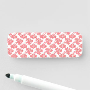 Porte-nom un motif à fleurs rouge et blanc sur fond blanc
