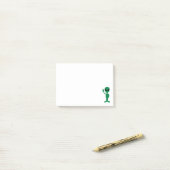 Post-it® Nous venons en petite silhouette d'alien d'homme (Sur un bureau)