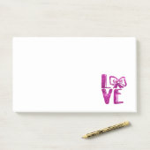 Post-it® parties scintillant de l'archet rose (Sur un bureau)
