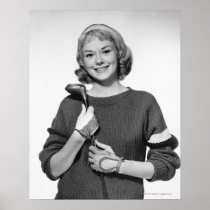 Poster Femme tenant le club de golf