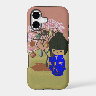 Poupée mignonne de kokeshi avec l'arbre de fleurs