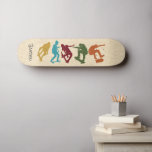 Pour Skateboarders Skateboard Graphics Collage<br><div class="desc">Surprenez votre patineur favori avec un skate deck personnalisé. Il présente des illustrations de style silhouette de skateboarders en jaune moutarde, bleu turquoise, rouge foncé, vert et orange rouille dressées contre un arrière - plan à faux grain de bois et est prêt à être personnalisé avec un nom en lettres...</div>