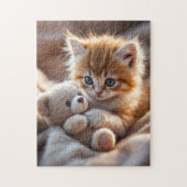 Puzzle Fluffy red kitten playing with a tiny teddy bear, (Vertical)