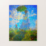Puzzle Monet Woman avec un parasol<br><div class="desc">Jigsaw Puzzle avec Camille,  la femme de Claude Monet,  tenant un parasol,  et leur fils Jean,  se promener dans un champ vert vif soufflé par le vent pendant une journée d’été. Un grand cadeau Monet pour les amateurs d'impressionnisme et d'art français.</div>