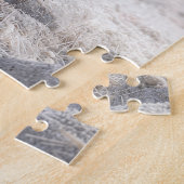 Puzzle Plume blanc sur un cairn de plage (Côté)