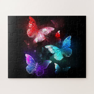 Puzzle Trois papillons lumineux sur fond de nuit