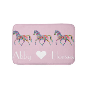 Rainboogpaarden op roze badmat