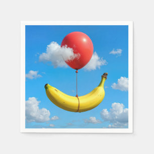 Rijpe banaan zwevend in de lucht met rode ballon servet