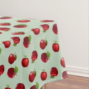 Rode appels op lichtgroene tafelkleed