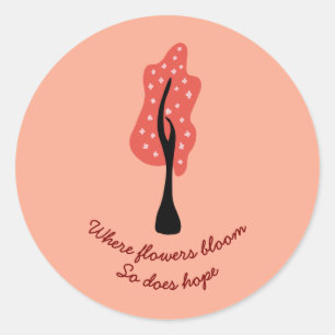 Rode boom in bloei met roze bloemen en citaat ronde sticker