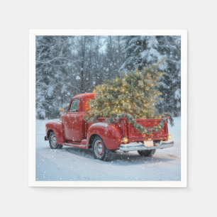 Rode retro truck met kerstboom in sneeuwvlokken servet